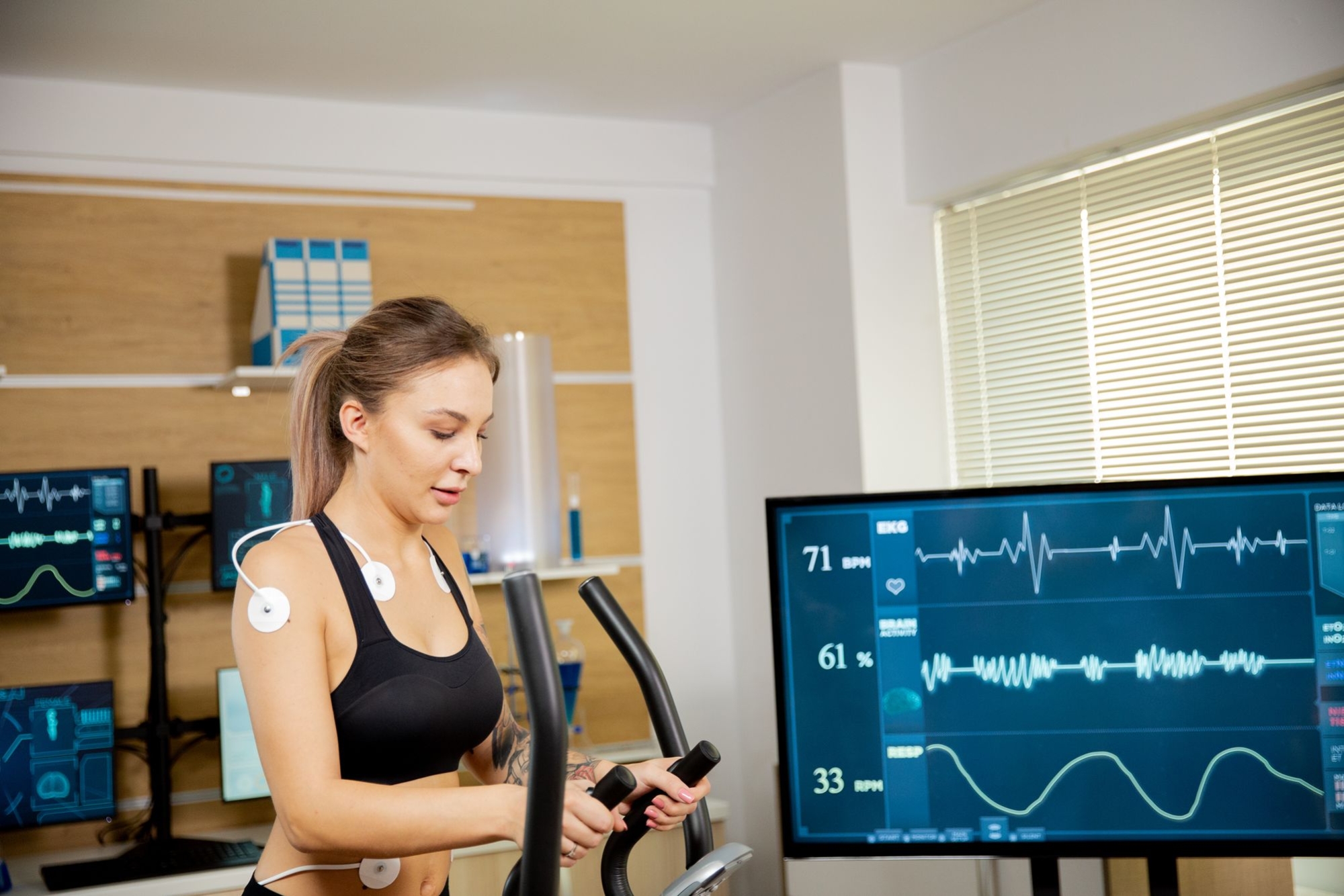 m_female-athlete-who-makes-physical-effort-stepper-has-electrodes-attached-it-results-are-seen-screen-sports-laboratory